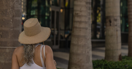 woman in hat tropical miami palms 