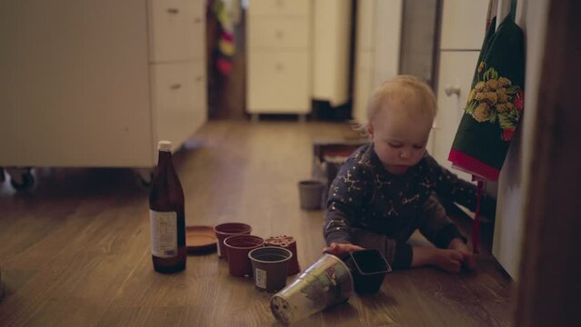 Lockdown Shot Of Cute Baby Boy Playing With Pots At Home - Jablonec nad Nisou, Czechia