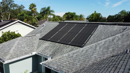 Aerial drone photo of solar panels on shingle roof of Florida house