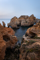 Fototapeta na wymiar Landscape with rocks and sea stacks at Ponta da Piedade, Lagos, Algarve (Portugal) at sunrise.