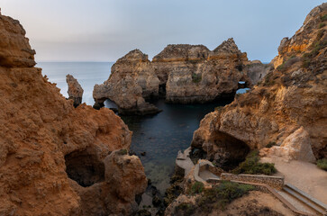 Landscape with rocks and sea stacks at Ponta da Piedade, Lagos, Algarve (Portugal) at sunrise.
