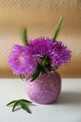 Bouquet of beautiful wildflowers in vase on light table