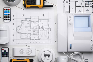 Flat lay composition with equipment for home security system on white wooden table