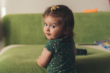 Closeup portrait of a beautiful cute baby's expression at home. Happy family, childhood. Beauty face. Closeup portrait.