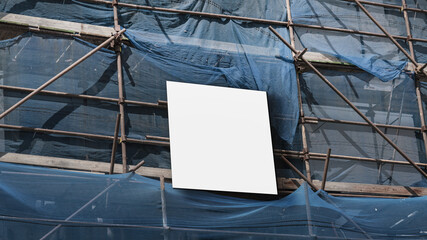 Blank information board fixed on scaffolding on construction site outside. Mock up and template.