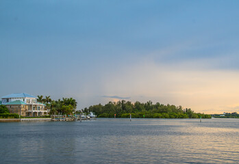 Dusk to Dawn over Sarasota Bay, Florida. Colorful stormy skies with Longboat Key and Sarasota downtown skyline in the distance. Light and colors.