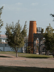 Park with brick mill and large trees