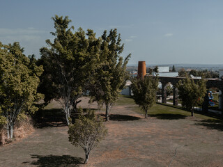 Park with brick mill and large trees