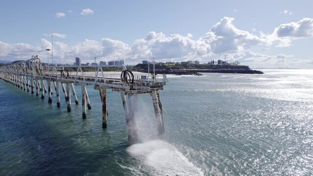 Sand-water Mixture Being Pumped Out From Tweed River Entrance Through Sand Bypassing Facility On TSB Jetty In Australia. drone orbit