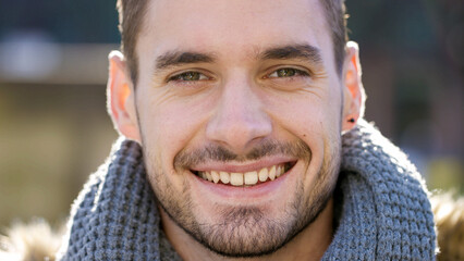 Portrait of handsome male smiling to camera outdoors