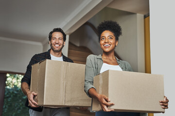 New house, moving and happy couple carrying boxes while feeling proud and excited about buying a house with a mortgage loan. Interracial husband and wife first time buyers unpacking in dream home - obrazy, fototapety, plakaty