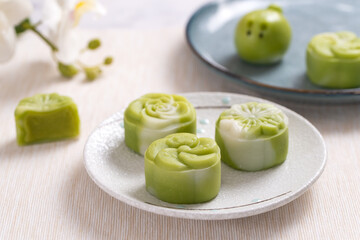 Traditional Chinese mid autumn festival dessert snowy skin mooncakes. The flavor is matcha green...