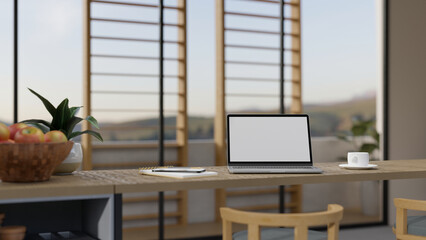 Minimal comfortable workplace on a wood kitchen tabletop with portable laptop mockup