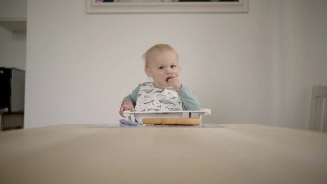 Lockdown Shot Of Cute Baby Boy Eating Apple On Table At Home - Jablonec nad Nisou, Czechia