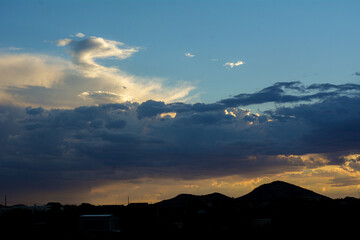 Gorgeous Sunset with Golden Sun Rays Shining Through Clouds