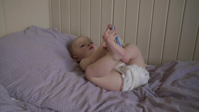 Lockdown Shot Of Toddler Playing With Toothbrush On Bed - Jablonec nad Nisou, Czechia