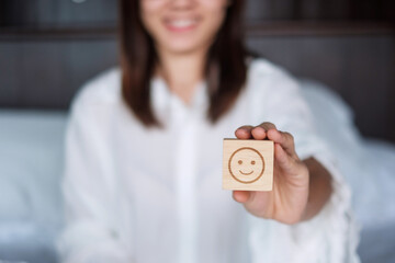 Happy Woman holding smile emotion face block. Customer choose Emoticon for user reviews. Service...