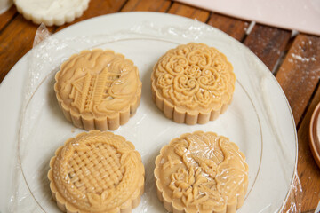 Raw mooncake placed in a baking tray by a window in a lifestyle setting