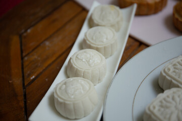 Retro vintage style Chinese mid autumn festival foods. Traditional mooncakes on table setting
