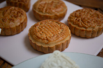 Retro vintage style Chinese mid autumn festival foods. Traditional mooncakes on table setting
