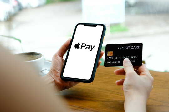 Bangkok. Thailand. AUGUST 17,2022 : Businessman holding a iPhone 11 with credit card and service Apple Pay on the screen. iPhone 11 was created and developed by the Apple inc.