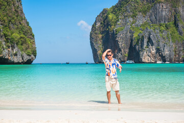happy tourist man at Maya Bay beach on Phi Phi island, Krabi, Thailand. landmark, destination...