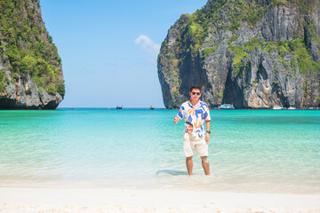 happy tourist man at Maya Bay beach on Phi Phi island, Krabi, Thailand. landmark, destination Southeast Asia Travel, vacation and holiday concept