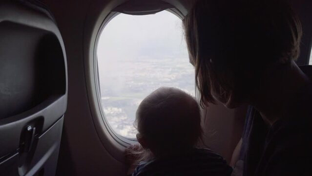 Mother And Son Looking At Clouds From Airplane While Traveling On Vacation - Jablonec nad Nisou, Czechia