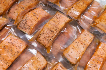 freeze cooked salmon in vacuum packs on grunge table, concept of food preservation, good work from home lunch idea, quick food on bysy day, time-saving meal for lockdown period