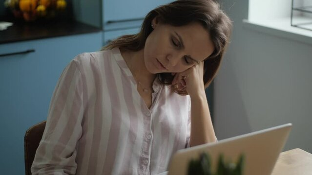 Lady is very tired and exhausted from problems at work or family. She could have signs of depression, frustration or anxiety. Her sad mood is fool of irritation, emotional disappointment.