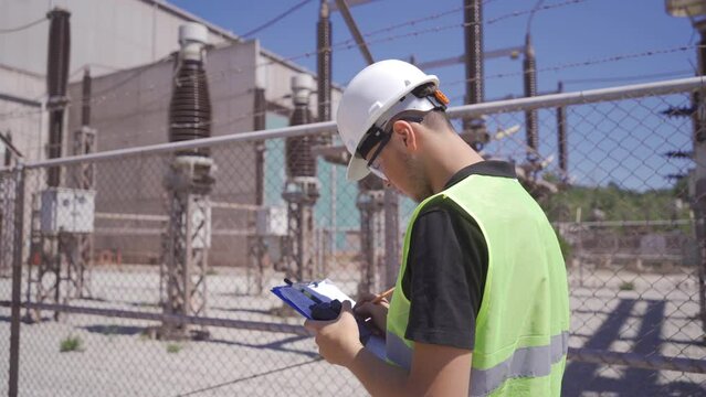Thermal power station switchyard.
Engineer working in switchyard.
