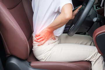 woman with her back sprain while driving car long time, back body ache due to Piriformis Syndrome, Low Back Pain and Spinal Compression. Ergonomic and medical concept