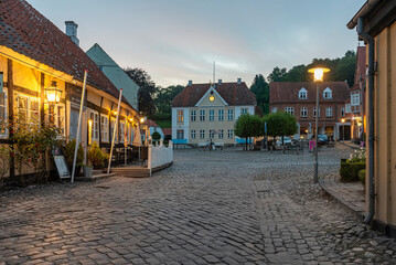 Fototapeta na wymiar old cobblestone square with a half-timbered hotel in the evening twiligt hour