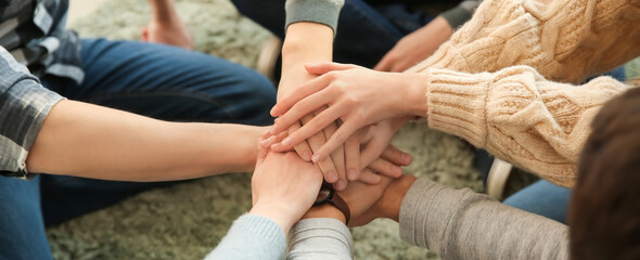 Group of people putting hands together, closeup