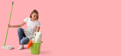 Pretty woman with cleaning supplies on pink background with space for text