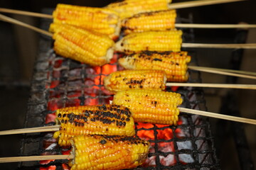 Delicious maize is being sold on the street of Varanasi in India during rainy season. Roasted and...