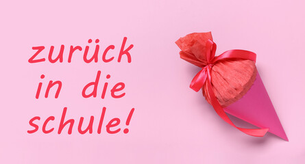 School cone and text ZURUCK IN DIE SCHULE (BACK TO SCHOOL) on pink background