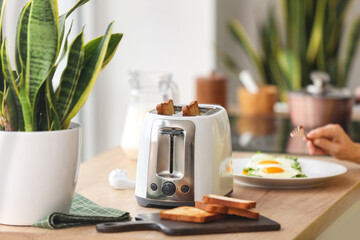 Modern toaster on kitchen table