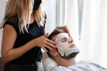 Obraz na płótnie Canvas Cropped photo of a man receiving a facial skin treatment in a salon