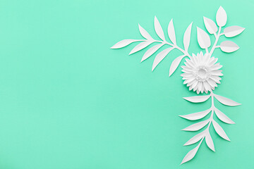 Origami flower and leaves on color background