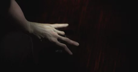 Gordijnen Image of hand walking in dark space © vectorfusionart