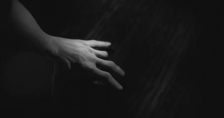 Zelfklevend Fotobehang Image of hand walking in dark space © vectorfusionart