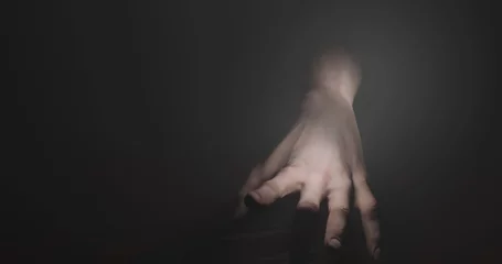 Rolgordijnen Image of hand walking in dark space © vectorfusionart