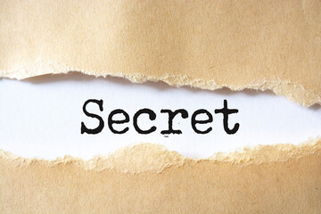 Torn paper revealing the words "secret"