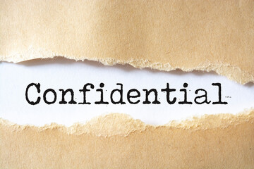 Torn paper revealing the words "Confidential"