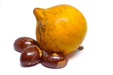 white background One yellow ripe peach and three seeds