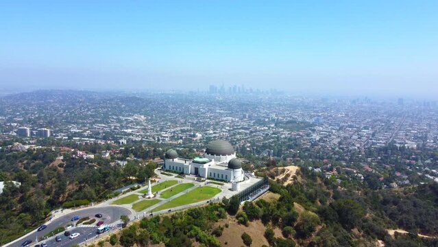 Griffith Park Observatory and view of Downtown Los Angeles, drone forward