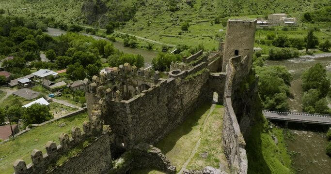 Abandoned Ruined Fortress Of Khertvisi Towering In The Small Village Within The Caucasus Mountains In Southern Georgia. Aerial Drone Shot