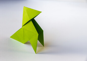 Green paper hen origami isolated on a white background