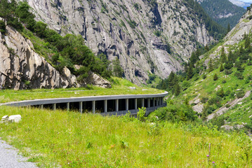Scenic landscape with avalanche protection gallery of Swiss mountain pass road at Schöllenen Gorge...